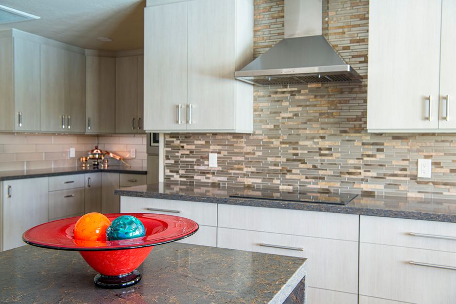 A kitchen with granite countertops and white cabinets.